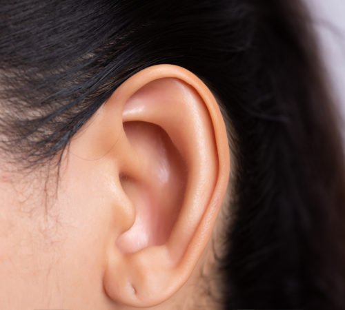 Close up young asian woman ear with Ear piercing. Healthcare and ear cleaning concept.